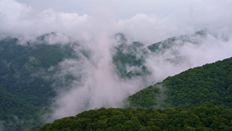 majestic cinematic shot over misty fog-draped smoky peaks