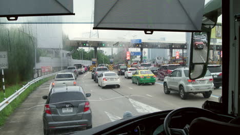 traffic congestion in front of an expressway tollgate in the middle of bangkok, thailand.