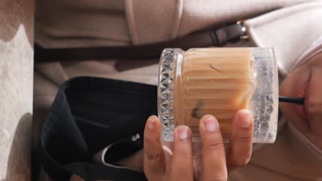 person holding iced coffee