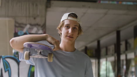 caucasian skateboarder in a ruined building.