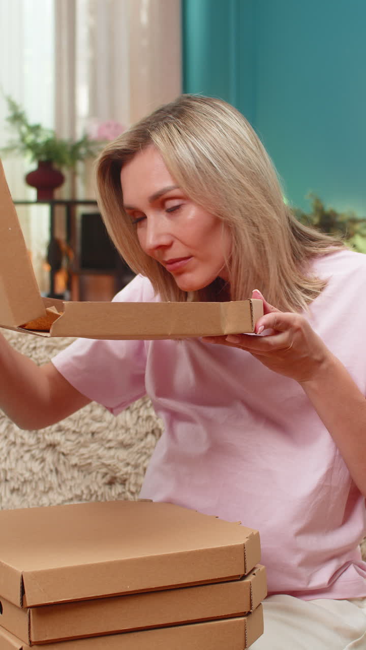 Pregnant woman paying pizza order with banking app card taps smartphone excited for big tasty dinner