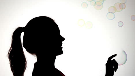 Silhouette-of-attractive-woman-popping-a-bubble