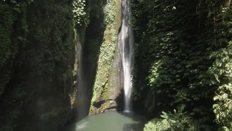 aerial pulls in to sekumpul waterfall in vertical grotto in bali