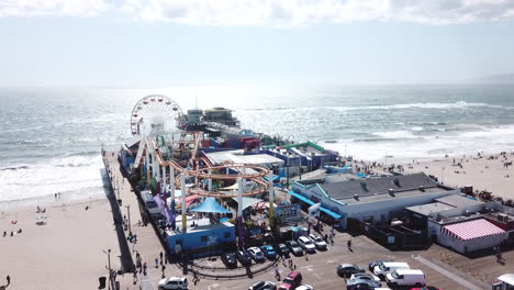 santa monica pier dock with carnival fair rides and a parking lot