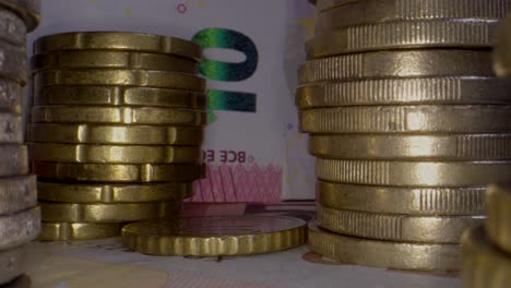 dolly zoom out showing ten euro banknote and stack of coins,close up