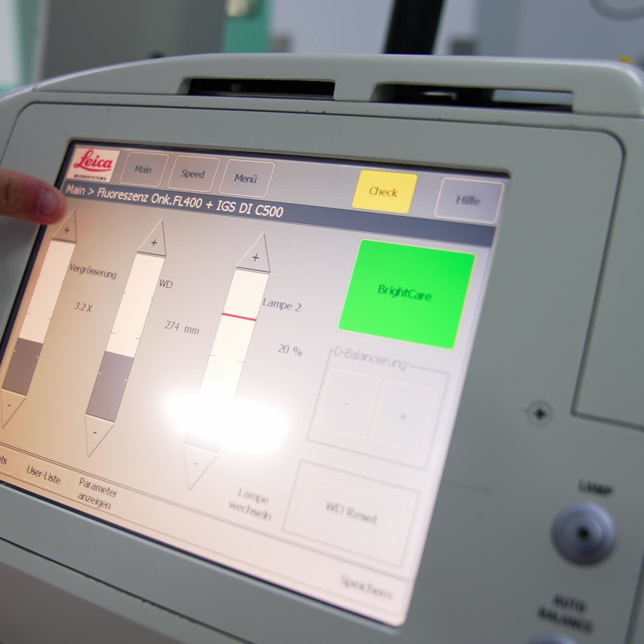 Male hand touches the sensor screen of the modern apparatus. Doctor presses the buttons changing parameters on the screen of equipment
