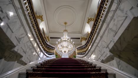 grand staircase with crystal chandelier in a luxurious building