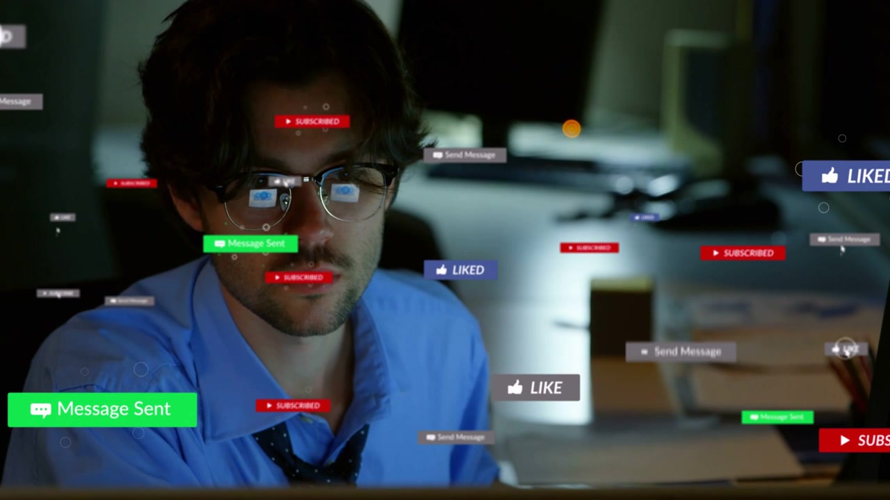 Male worker sitting at desk, badges multiplying around him, causing message checking for marketing
