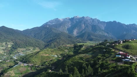 beautiful drone shot of the fields of kundasnag showing mount kinabalu in the background sabah malaysia daylight