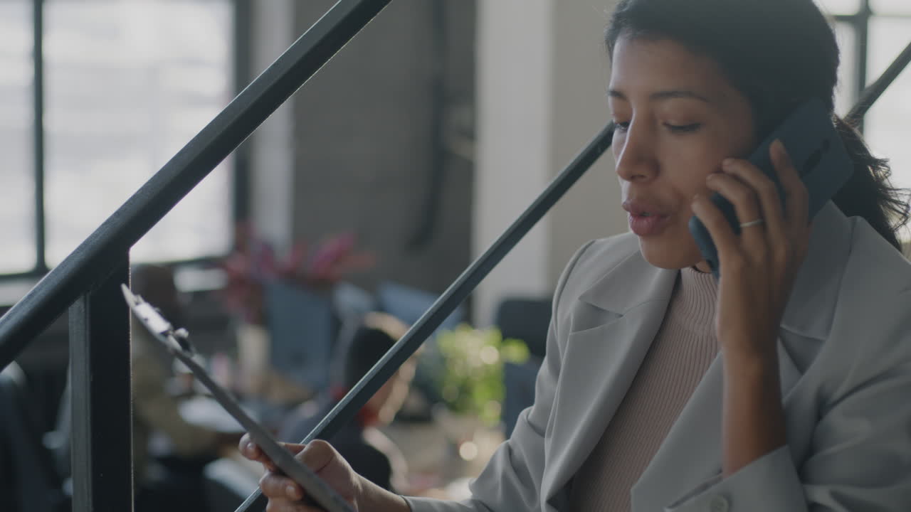 Business Woman on Stairs Talking on the Phone