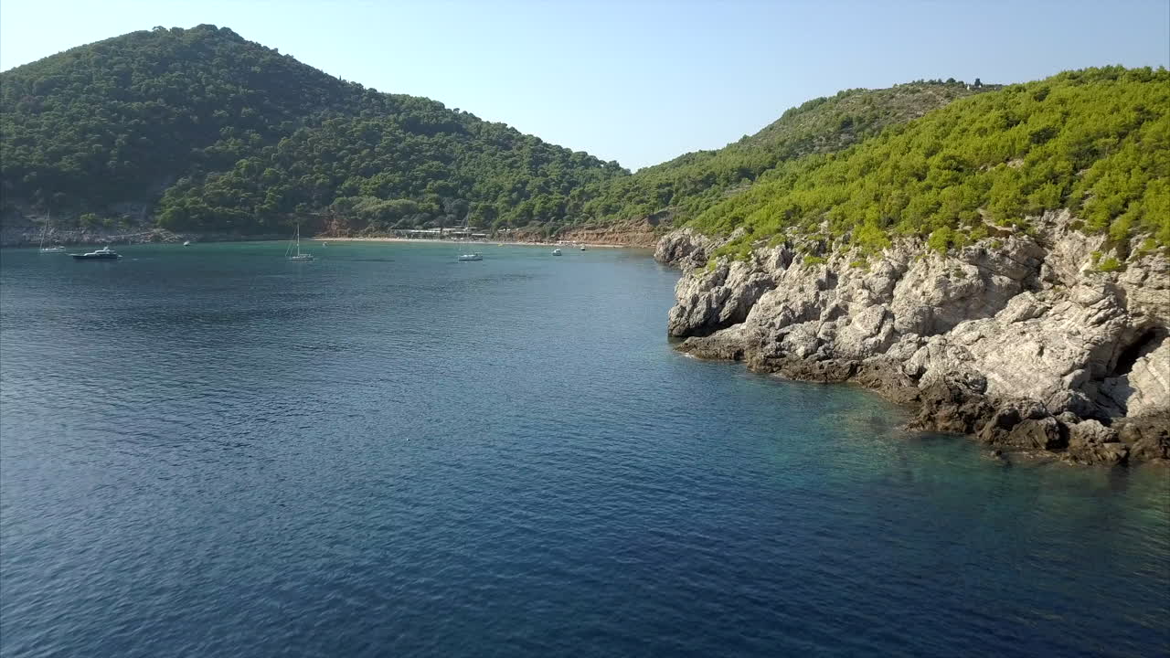 Lopud island coast line, close up of rocks and waves, aerial footage