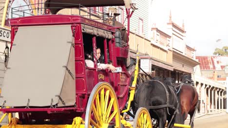 a horse-drawn carriage moves through sovereign hill