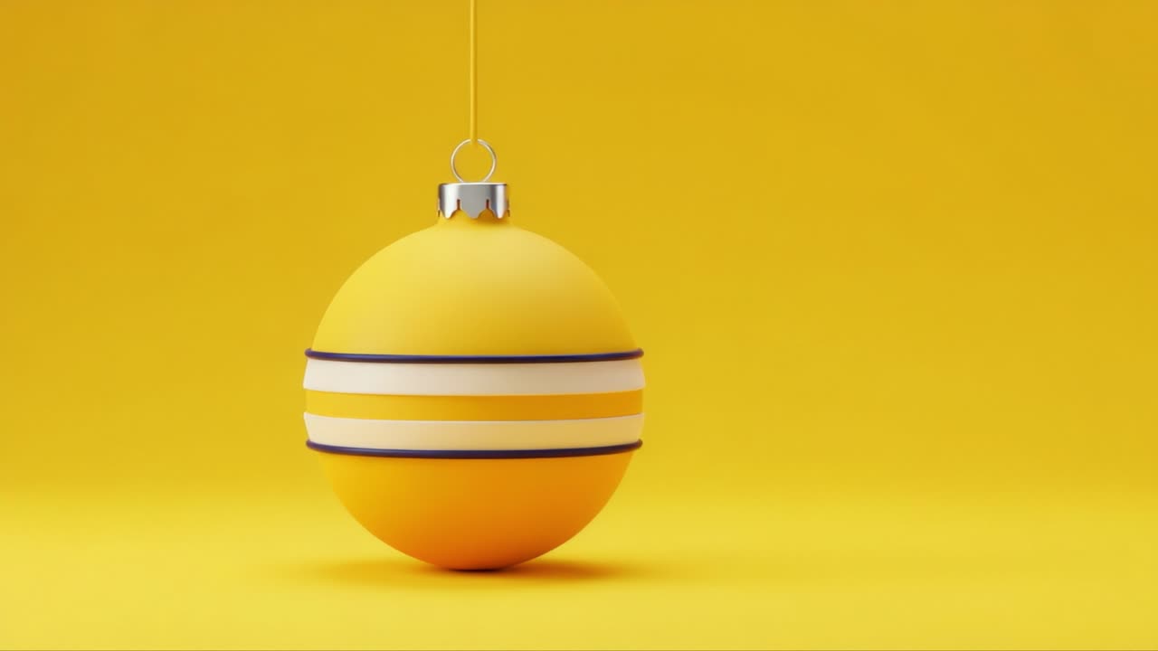 A vibrant yellow ornament hanging against a matching background, showcasing a sleek design with white and purple stripes, creating a cheerful and festive atmosphere