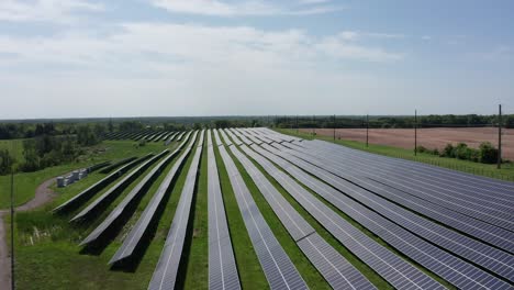 Descending-aerial-close-up-shot-of-an-expansive-solar-farm-in-rural-Minnesota