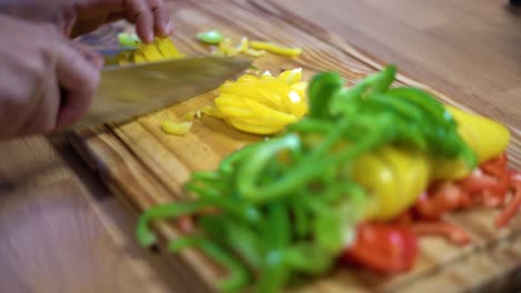 slicing bell peppers in julienne on wooden board kitchen healthy healthy diet