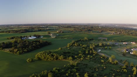 cinematic aerial flight over rural landscape in midwest america at dawn