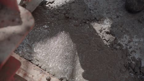 Slow-motion-of-a-worker-levelling-concrete-on-the-floor-with-a-trowel