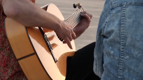 unrecognizable woman applauding faceless male guitar player