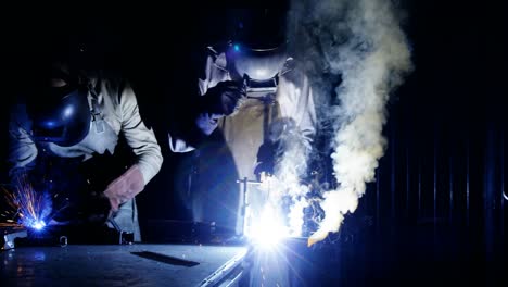 welders welding a metal