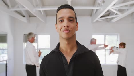 mixed-race-male-dance-teacher-taking-a-ballroom-dancing-class-at-a-dance-studio