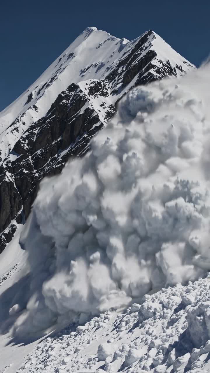 Dynamic video captures a dramatic avalanche cascading down a snowy mountain slope