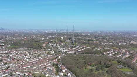 High-dolly-forward-drone-shot-of-two-antenna-in-south-London-Crystal-palace-tower-radio