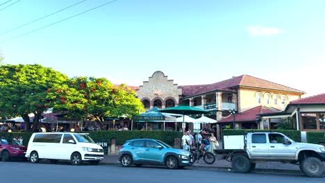 vehicles and people in a bustling street scene