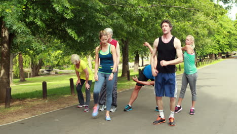 athletic group stretching and running