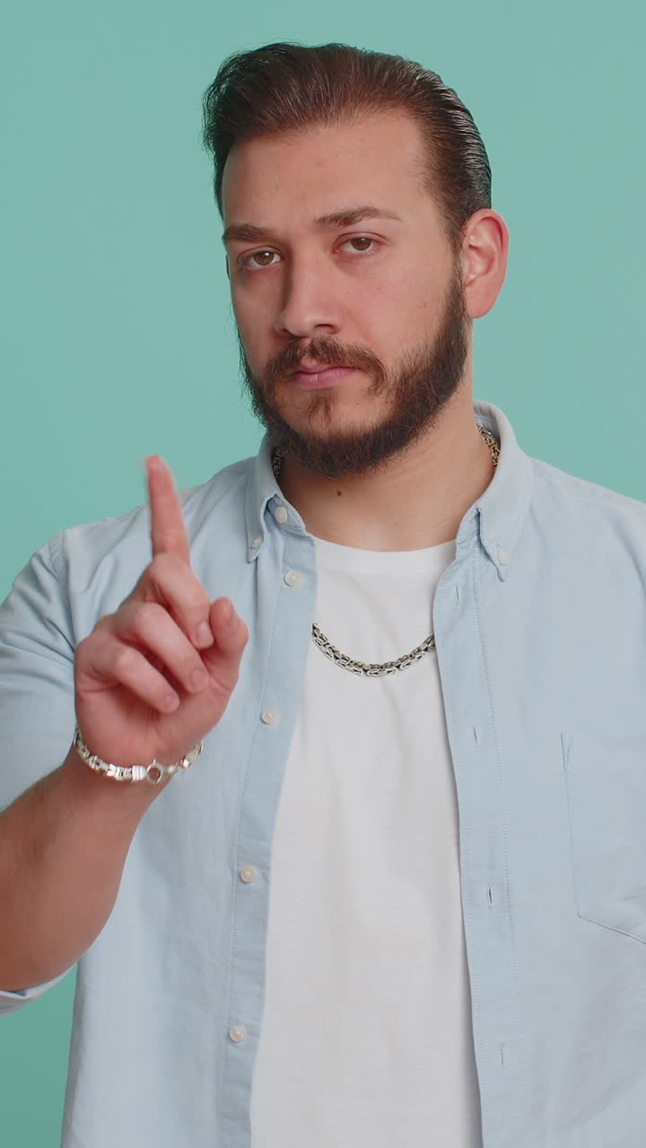 Lebanese handsome man shakes finger and saying no be careful avoid danger mistake disapproval sign