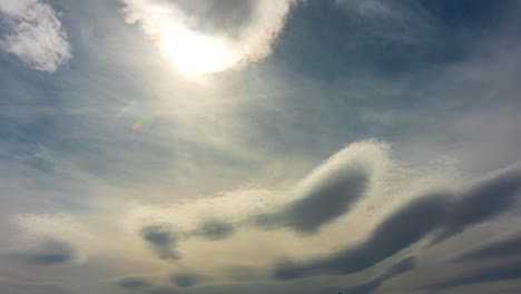 vapor and heat waves from between the sun and the cloudscape on a hot day - sky only time lapse with copy space