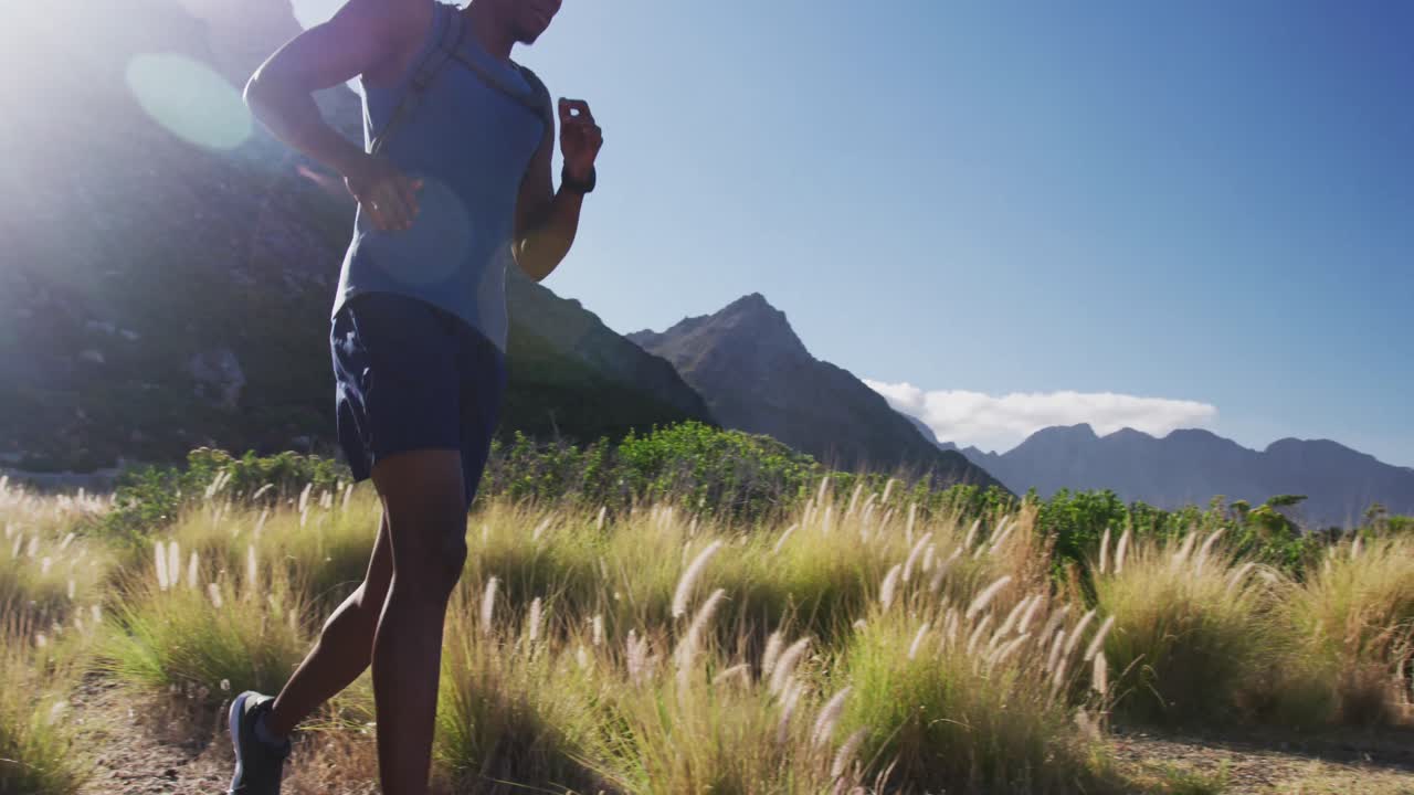 African american man cross country running in countryside on a mountain