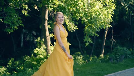 cu slow motion young beautiful girl in beautiful yellow fluttering dress