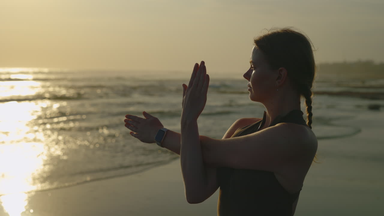 Woman Stretching on Beach at Sunrise