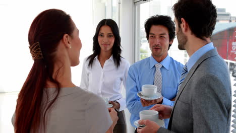 Business-team-having-coffee-and-chatting