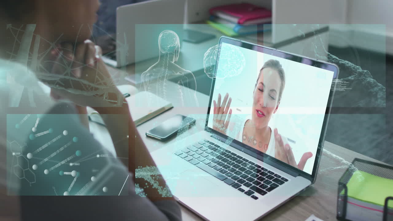 Man leaning forward at desk, viewing laptop telemedicine session with molecular graphics overlay