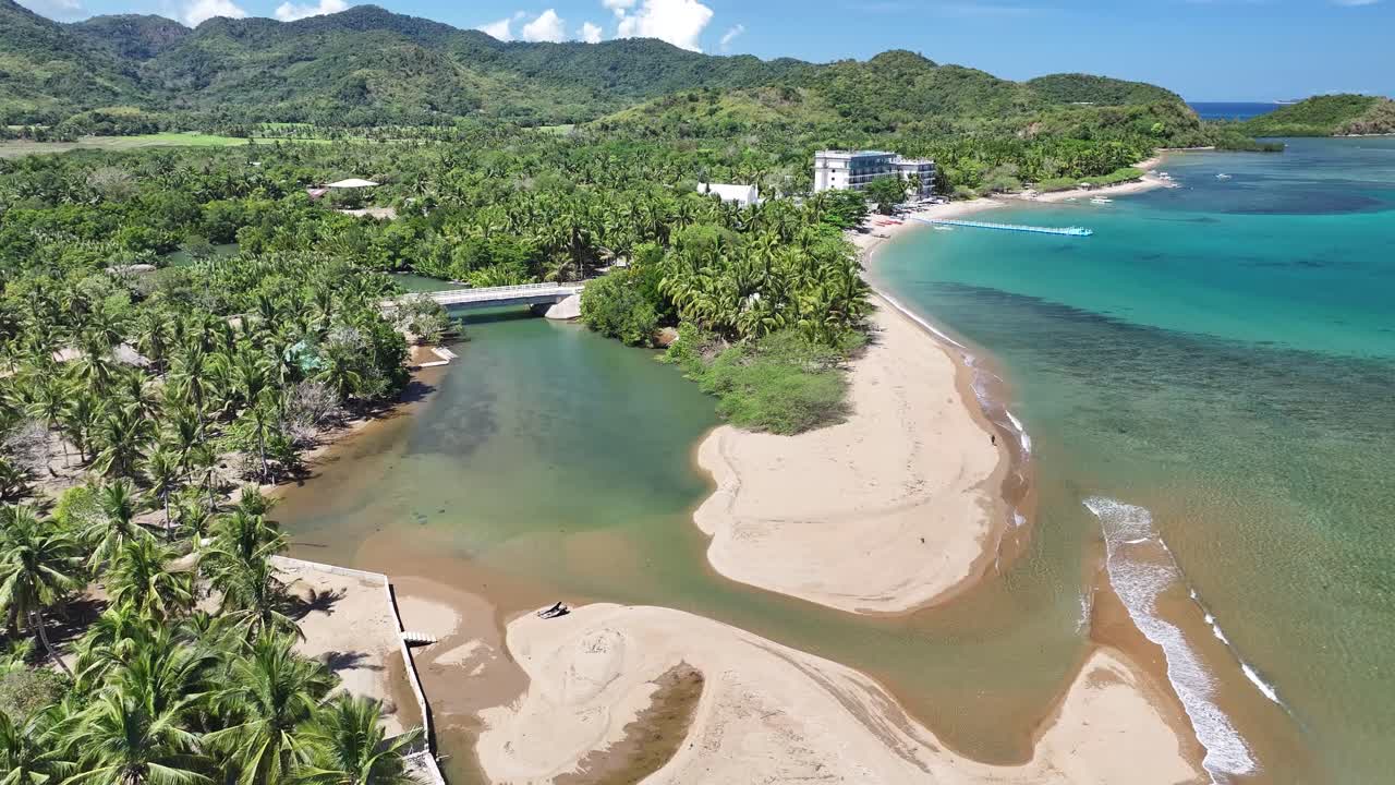 Remote village on Busuanga Island with scenic beach, clear turquoise water, and tropical palm trees