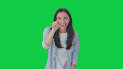 Happy-indian-girl-pointing-and-calling-someone-Green-screen