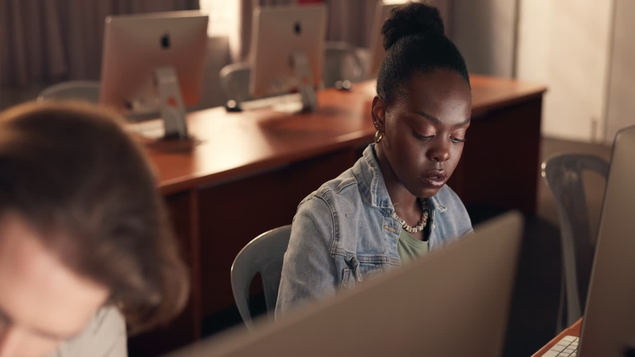 Student working in a computer lab at night