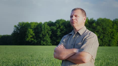 confident middle-aged farmer standing in the field. master of business concept. steadicam shot