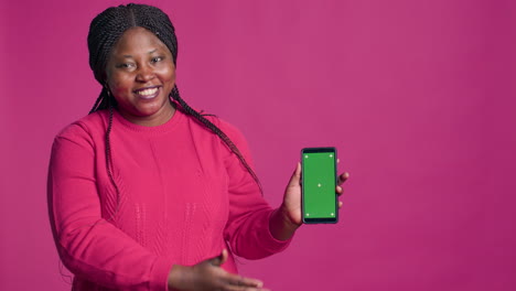 Female-Holding-Device-With-Green-Screen