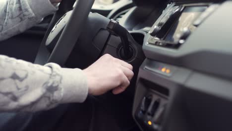 starting car with keys in hand, side closeup view from inside
