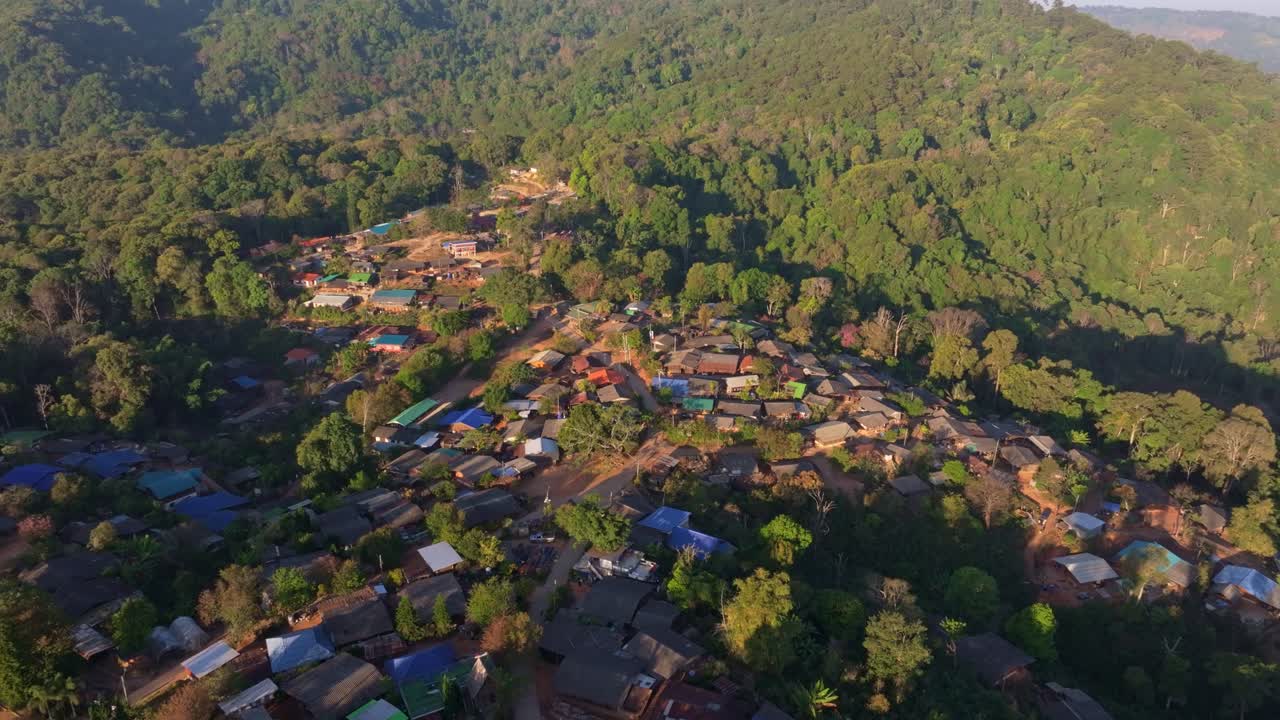 Peaceful mountain dwellings hidden among green hills, Thailand