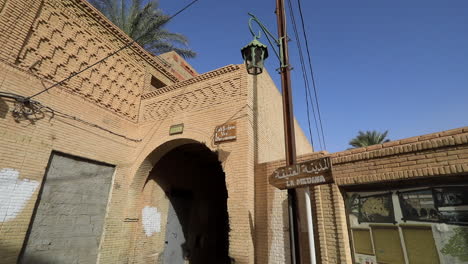 sunlit view of a traditional muslim street in sbeitla with arched entryway