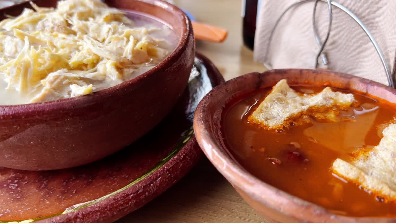Sweeping view of white and red pozole, traditional Mexican dishes for September