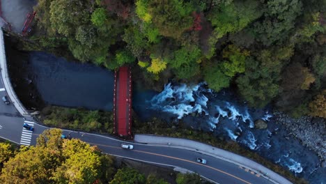 overhead view of beautiful red shinkyo bridge in nikko during autumn with river