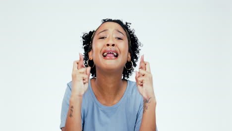 hope, face and nervous woman with fingers crossed