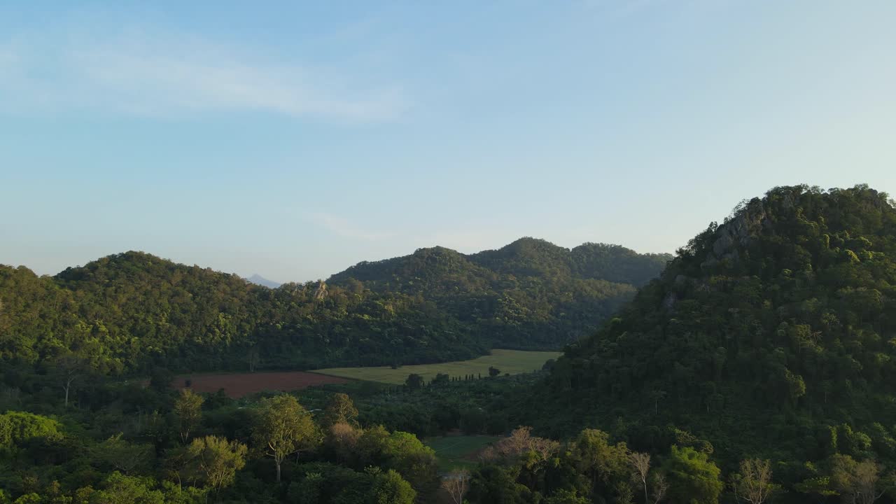 Ascending aerial footage of this valley and hills at a farm land in Pakchong, Khao Yai, Thailand