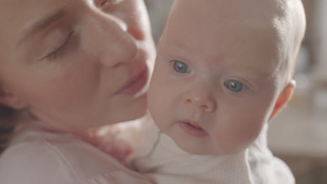 mother kissing her baby