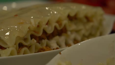 Low-Angle-Dolly-View-Of-Fresh-Lasagna-Resting-On-Plate