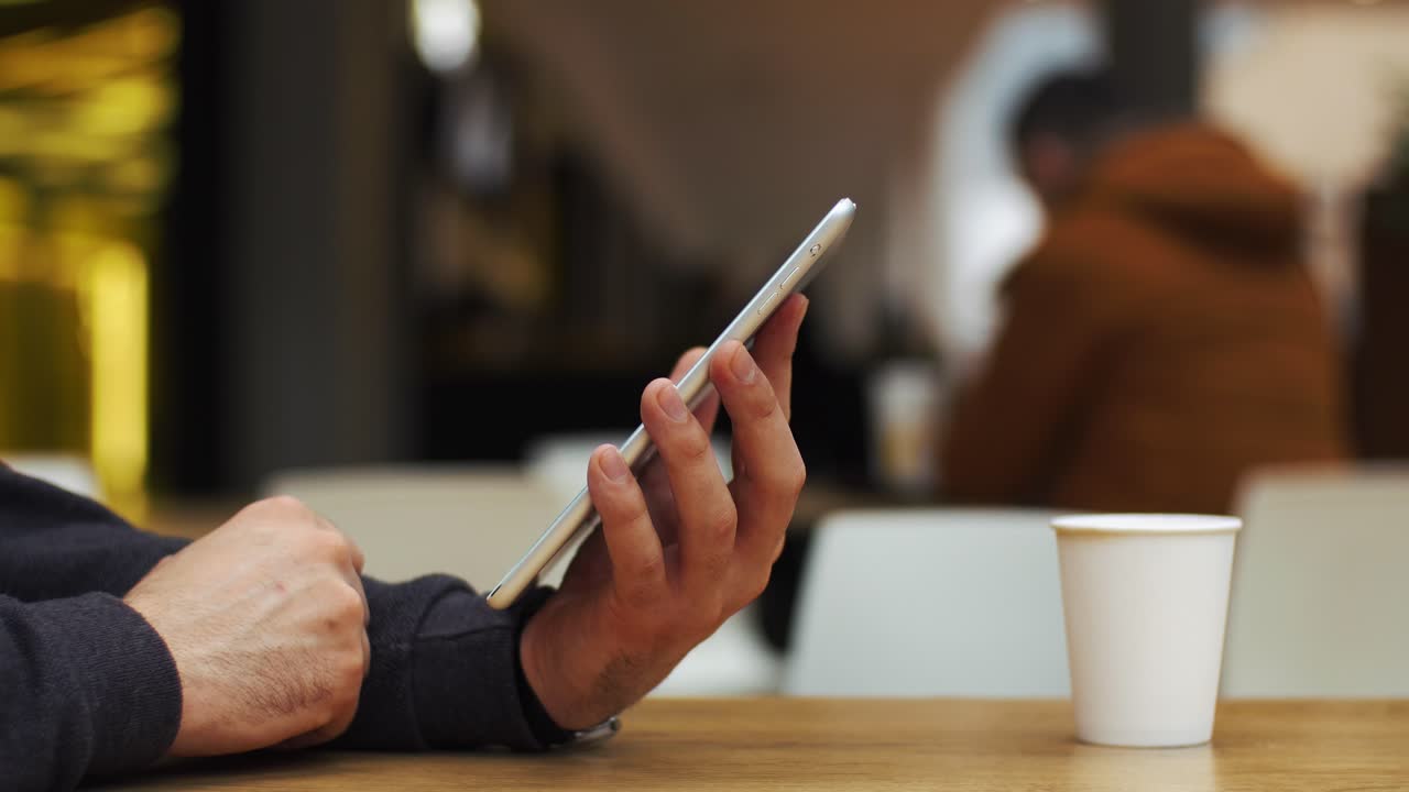 Man using smartphone at a cafe